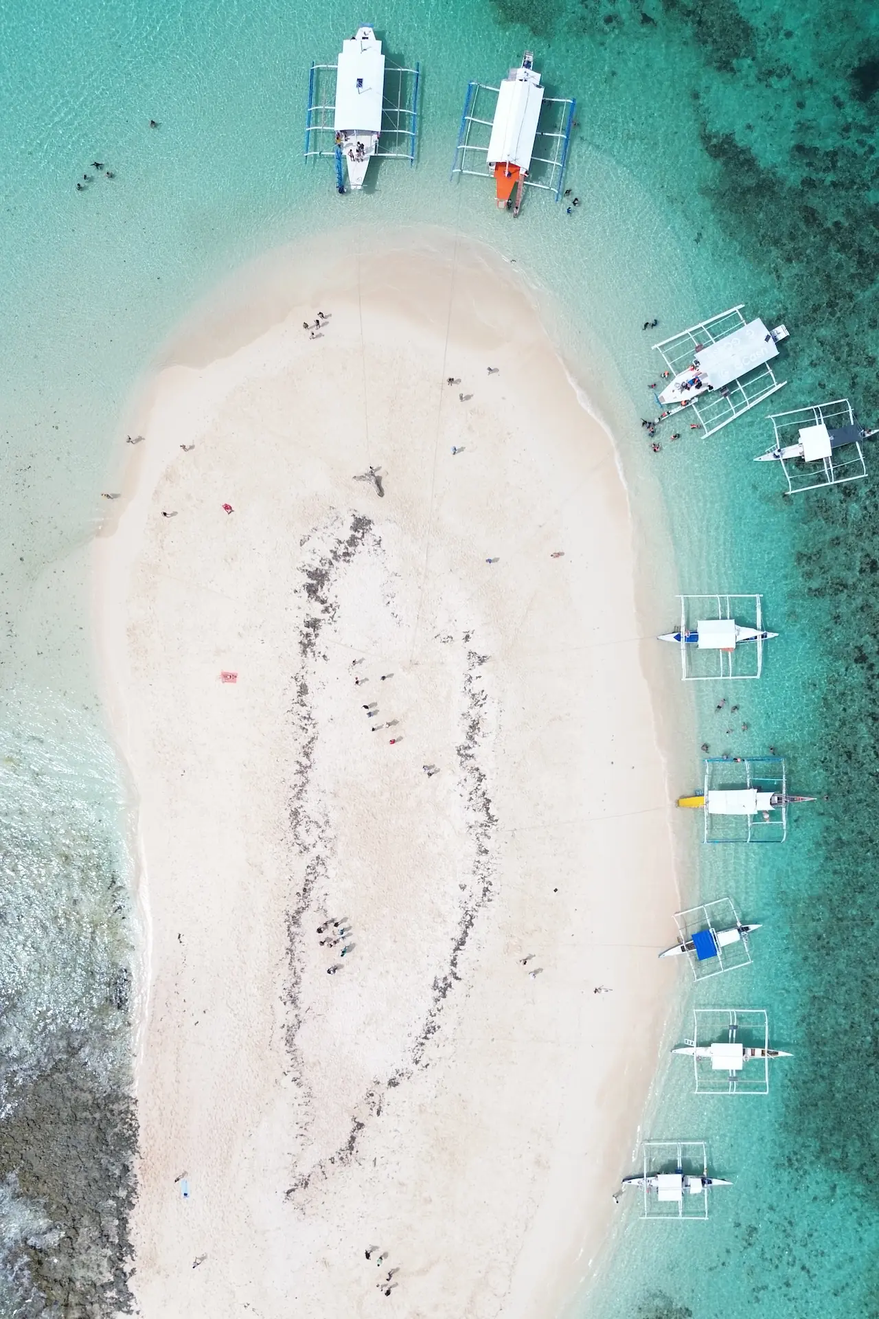 Siargao travel guide aerial view of boats on a sandbar