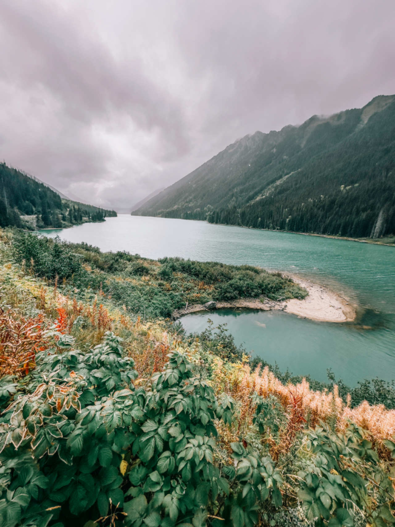 Symmetrical mountains framing the calm surface of Duffy Lake along Highway 99 in British Columbia.