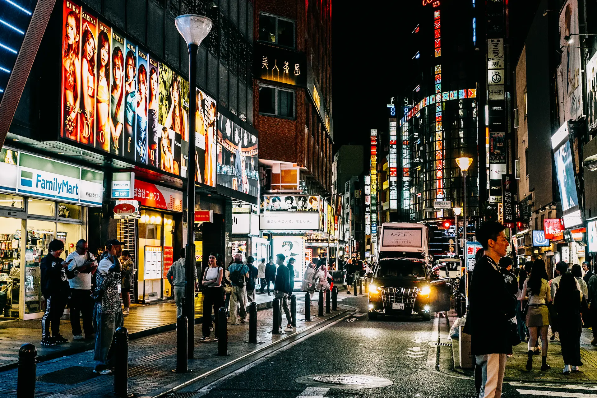 Vibrant neon signs light up a bustling street in the Kabukicho district of Tokyo during a Japan travel itinerary.