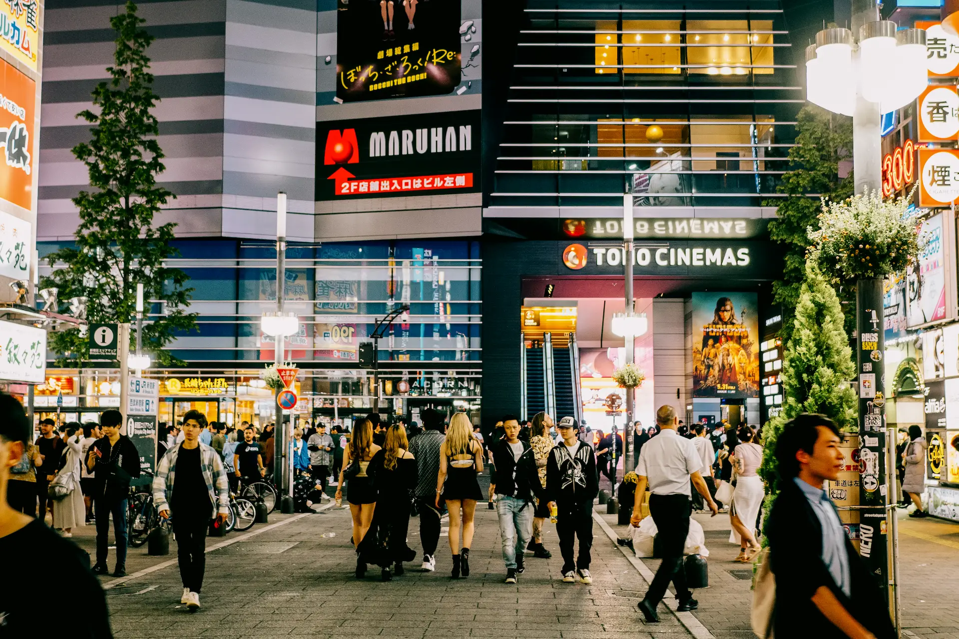 A lively night view looking down Central Road in Kabukicho, Shinjuku towards the illuminated TOHO Cinemas building during a Japan travel itinerary.